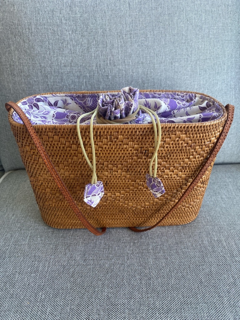 handwoven rattan shoulder bag, often referred to as an Ata grass bag